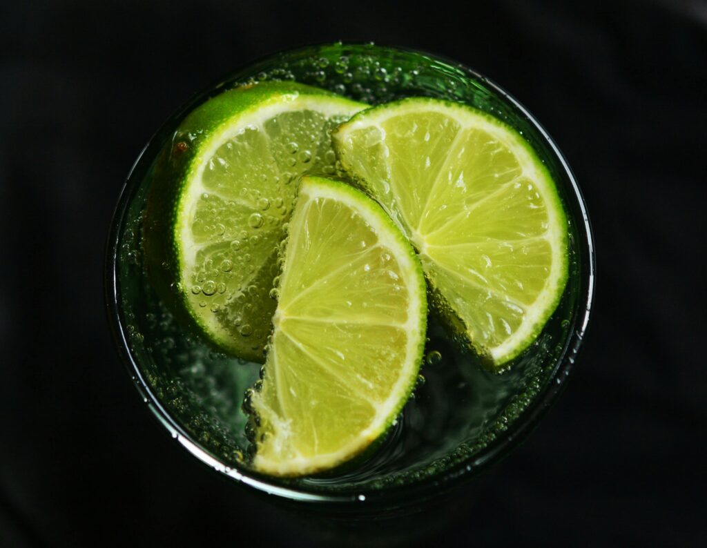 Close-up of fresh lime slices in a glass of sparkling water, refreshing concept.